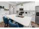 Bright kitchen featuring white cabinetry, a large island with seating, and stainless-steel appliances at 7516 O'Hara St, Huntersville, NC 28078