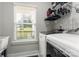 Laundry room with a window, a washing machine, and dryer setup for efficiency and convenience at 7516 O'Hara St, Huntersville, NC 28078