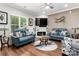 Bright living room with a modern fireplace, stylish decor, hardwood floors, and a large window at 7516 O'Hara St, Huntersville, NC 28078