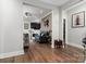 Open-concept living room featuring wood floors, fireplace, and stylish furnishings at 7516 O'Hara St, Huntersville, NC 28078