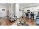 Open concept living space with hardwood floors, modern furnishings, and a view to the kitchen at 7516 O'Hara St, Huntersville, NC 28078