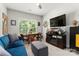Living room featuring comfortable seating, a modern TV and a fireplace creating a cozy and inviting atmosphere at 7516 O'Hara St, Huntersville, NC 28078