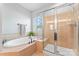 Elegant bathroom showcasing a soaking tub, tiled shower, and neutral color palette at 7612 Turley Ridge Ln, Charlotte, NC 28273