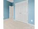 Bedroom featuring bright blue walls, carpeted floor, and closet doors at 7612 Turley Ridge Ln, Charlotte, NC 28273