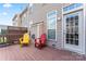 Cozy deck featuring painted Adirondack chairs and rear access to home at 7612 Turley Ridge Ln, Charlotte, NC 28273