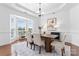 A formal dining room features a bay window, modern lighting, and stylish decor at 7612 Turley Ridge Ln, Charlotte, NC 28273