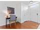 Bright hallway with hardwood floors, a desk, and a white front door at 7612 Turley Ridge Ln, Charlotte, NC 28273