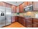 Gourmet kitchen featuring stainless steel appliances and rich wood cabinetry at 7612 Turley Ridge Ln, Charlotte, NC 28273