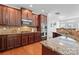 A gourmet kitchen features granite countertops, stainless steel appliances, and hardwood floors at 7612 Turley Ridge Ln, Charlotte, NC 28273