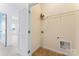 Laundry room with hookups, tile flooring, shelving, and blue walls in the hallway at 7612 Turley Ridge Ln, Charlotte, NC 28273