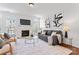 A modern living room boasts a fireplace, neutral tones, and abundant natural light at 7612 Turley Ridge Ln, Charlotte, NC 28273