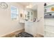 Bright bathroom with vanity, makeup area, and open shelving at 8330 Kneller St, Charlotte, NC 28215