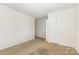 Spacious bedroom with neutral carpet, built-in shelving, and bright natural light at 8330 Kneller St, Charlotte, NC 28215