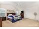 Spacious bedroom with vaulted ceiling, plush carpet, and two windows for natural light at 8330 Kneller St, Charlotte, NC 28215