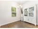 Bright dining room with wood floors, chandelier, window, and white cabinet for storage at 8330 Kneller St, Charlotte, NC 28215