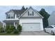 Charming two-story home with white siding and a two-car garage, nicely landscaped with lawn and bushes at 8330 Kneller St, Charlotte, NC 28215