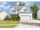Charming two-story home with a manicured lawn, white siding, and a spacious two-car garage at 8330 Kneller St, Charlotte, NC 28215