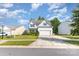 Well-kept two-story house with white siding, a two-car garage, and a green lawn on a sunny day at 8330 Kneller St, Charlotte, NC 28215