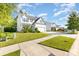 Inviting two-story home with manicured lawn, beautiful landscaping, and a wide driveway on a sunny day at 8330 Kneller St, Charlotte, NC 28215