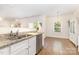 Bright kitchen featuring granite countertops, stainless steel appliances, and wood floors into the dining area at 8330 Kneller St, Charlotte, NC 28215