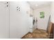 Well-organized laundry room with washer, dryer, storage, and tile flooring at 8330 Kneller St, Charlotte, NC 28215
