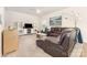 Comfortable living room showcasing a plush leather sofa, a ceiling fan, neutral walls, and carpeted floors at 8330 Kneller St, Charlotte, NC 28215