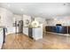 Open-concept living area flowing from modern kitchen with stainless appliances to a cozy living room space at 8330 Kneller St, Charlotte, NC 28215