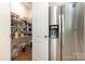 Spacious walk-in pantry with wire shelving next to stainless steel refrigerator at 8330 Kneller St, Charlotte, NC 28215