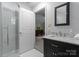 Stylish bathroom with marble countertops, modern vanity, and a convenient glass-enclosed shower at 9141 Covey Hollow Ct, Charlotte, NC 28210
