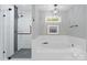 Modern bathroom with glass enclosed shower and luxurious soaking tub at 9141 Covey Hollow Ct, Charlotte, NC 28210