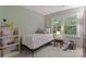 Comfortable bedroom featuring a window with privacy blinds and a charming decor at 9141 Covey Hollow Ct, Charlotte, NC 28210