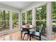 Breakfast nook with views of lush greenery through the surrounding windows at 9141 Covey Hollow Ct, Charlotte, NC 28210