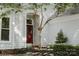 Inviting front porch with a red door, tasteful planters, and well-maintained landscaping at 9141 Covey Hollow Ct, Charlotte, NC 28210