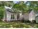 Charming home with red front door, manicured landscaping, and mature shade tree at 9141 Covey Hollow Ct, Charlotte, NC 28210