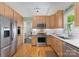 Updated kitchen featuring stainless steel appliances, custom wood cabinets and hardwood floors at 9141 Covey Hollow Ct, Charlotte, NC 28210