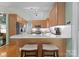 Well-equipped kitchen featuring a breakfast bar, stainless steel appliances, and light wood cabinetry at 9141 Covey Hollow Ct, Charlotte, NC 28210