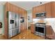 Kitchen featuring stainless steel appliances, ample wooden cabinetry, and hardwood flooring at 9141 Covey Hollow Ct, Charlotte, NC 28210