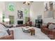 Bright living room features a fireplace, tall windows, and comfortable leather seating at 9141 Covey Hollow Ct, Charlotte, NC 28210