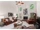 Open-concept living room with tall ceilings, a fireplace, and leather furniture set at 9141 Covey Hollow Ct, Charlotte, NC 28210