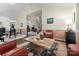 Open-concept living room with a stone coffee table, plush chairs, and seamless flow to other living areas at 9141 Covey Hollow Ct, Charlotte, NC 28210