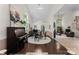 Open floor plan showcasing a piano, dining area, and seamless transition to the living room at 9141 Covey Hollow Ct, Charlotte, NC 28210