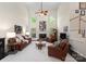 Spacious living room featuring high ceilings, a fireplace, and comfortable leather seating at 9141 Covey Hollow Ct, Charlotte, NC 28210