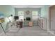 Well-lit home office featuring a large desk, comfortable seating, and ample storage at 9141 Covey Hollow Ct, Charlotte, NC 28210
