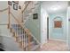 Elegant staircase with carpeted steps, a light wood banister, and fresh paint at 9141 Covey Hollow Ct, Charlotte, NC 28210