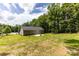 Expansive backyard featuring a patio, lush lawn, and mature trees, offering privacy and space at 1005 8Th Sw Ave, Conover, NC 28613
