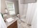 Bright bathroom with granite countertop, a single sink, tile flooring, and a shower with curtain at 1005 8Th Sw Ave, Conover, NC 28613