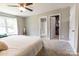 This carpeted bedroom features a ceiling fan, ensuite bath and walk-in closet at 1005 8Th Sw Ave, Conover, NC 28613
