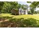 Single-story home with gray siding, brick foundation, two-car garage, and lush green lawn at 1005 8Th Sw Ave, Conover, NC 28613