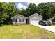 Charming single-story home with gray siding, brick foundation, two-car garage, and lush green lawn at 1005 8Th Sw Ave, Conover, NC 28613