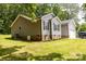 Side view of a single-story home with gray siding, brick foundation, and green lawn at 1005 8Th Sw Ave, Conover, NC 28613